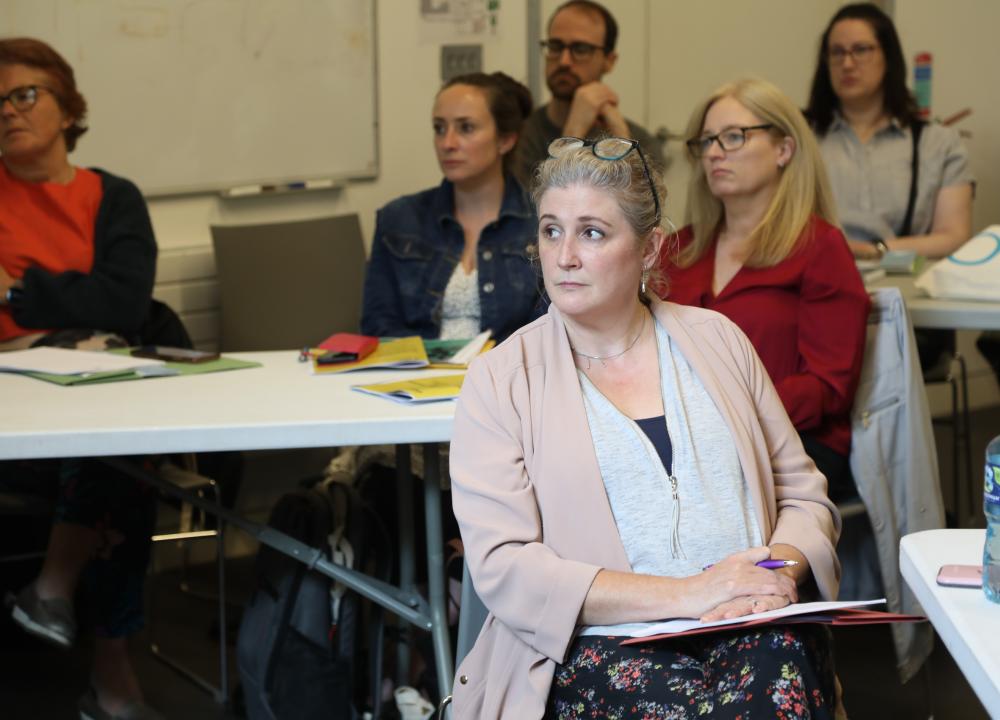 Photograph of attendees engaging in session facilitated by Maura McGinn